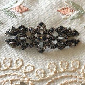 Vintage Brooch shown by its dated clasp with marcasite stone in center